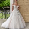 Bridal model wearing an elegant wedding gown with delicate floral detailing and a flowing skirt, photographed at CB Bridal Studio.