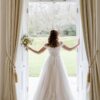 Bridal model wearing a romantic wedding gown with delicate lace details and a flowing silhouette at CB Bridal Studio.