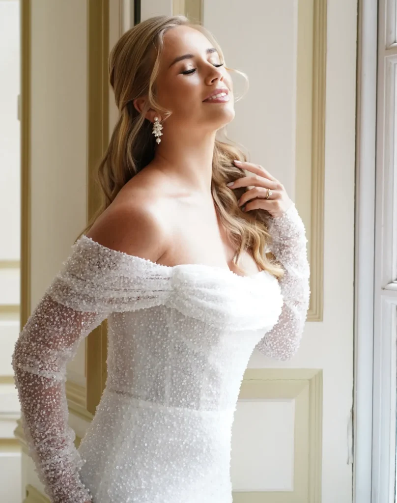 Bridal model showcasing the Dream wedding dress with an elegant flowing skirt and refined detailing, photographed for CB Bridal Studio.